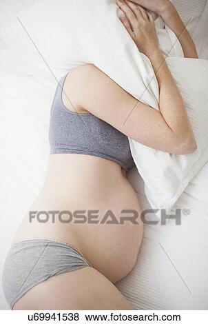 Pregnant woman sleeping View Large Photo Image Stock Photo - Pregnant woman sleeping. Fotosearch