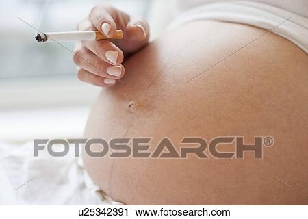 Stock Image - Pregnant woman smoking. Fotosearch