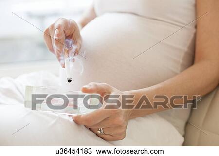 Pregnant woman smoking View Large Photo Image Stock Image - Pregnant woman smoking. Fotosearch