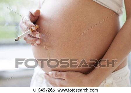 Pregnant woman smoking View Large Photo Image Stock Photography - Pregnant woman smoking. Fotosearch