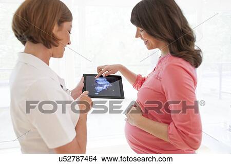 Pregnant woman with baby scan View Large Photo Image Picture - Pregnant woman with baby scan. Fotosearch
