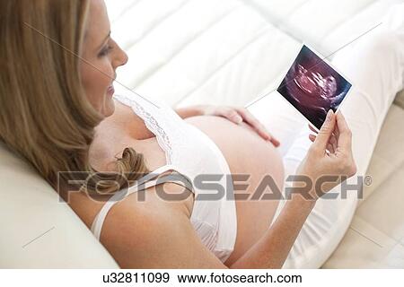Pregnant woman with baby scan View Large Photo Image Stock Photo - Pregnant woman with baby scan. Fotosearch