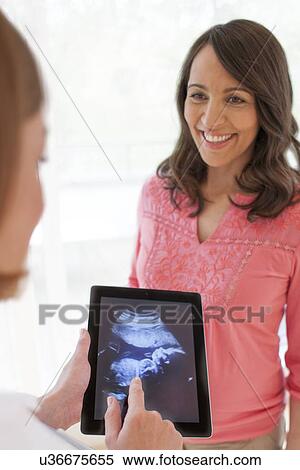 Pregnant woman with baby scan View Large Photo Image Stock Photography - Pregnant woman with baby scan. Fotosearch