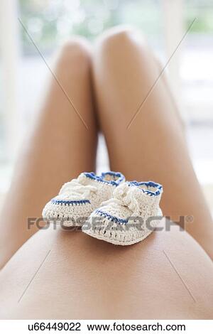 Pregnant woman with booties View Large Photo Image Stock Image - Pregnant woman with booties. Fotosearch