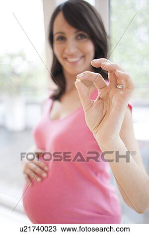 Pregnant woman with supplement View Large Photo Image Stock Image - Pregnant woman with supplement. Fotosearch