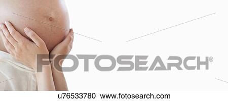 Stock Image - Pregnant woman's abdomen. Fotosearch