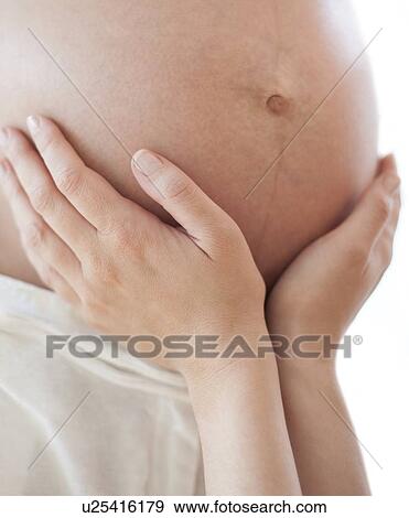 Stock Photo - Pregnant woman's abdomen. Fotosearch