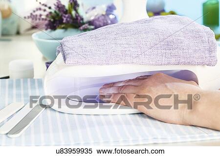 Stock Photography - Setting UV nail polish. Fotosearch