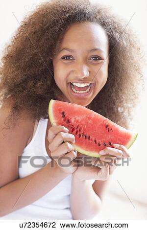 Teenage girl eating watermelon View Large Photo Image Stock Image - Teenage girl eating watermelon. Fotosearch