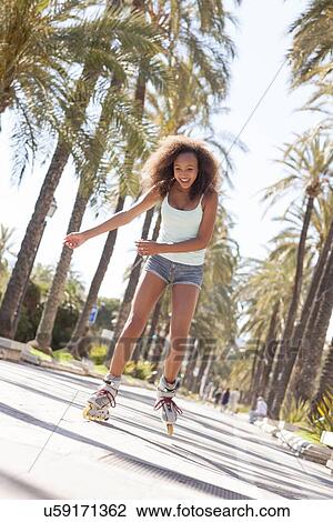 Stock Image - Teenage girl rollerblading. Fotosearch