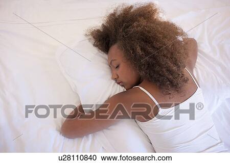 Stock Image - Teenage girl sleeping. Fotosearch