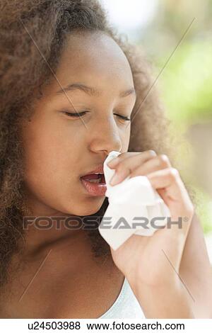 Teenage girl sneezing View Large Photo Image Stock Photo - Teenage girl sneezing. Fotosearch