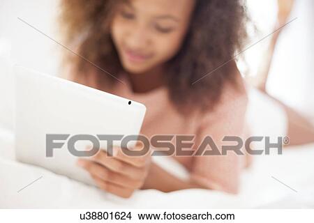 Teenage girl using a tablet computer View Large Photo Image Picture - Teenage girl using a tablet computer. Fotosearch