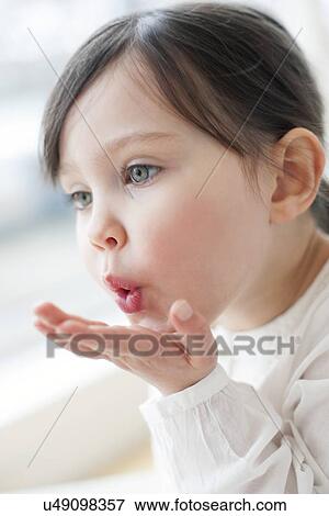 Three year old girl blowing a kiss View Large Photo Image Stock Photo - Three year old girl blowing a kiss. Fotosearch