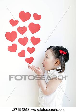 Stock Image - Three year old girl blowing kisses. Fotosearch