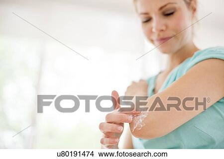 Woman applying body lotion View Large Photo Image Picture - Woman applying body lotion. Fotosearch