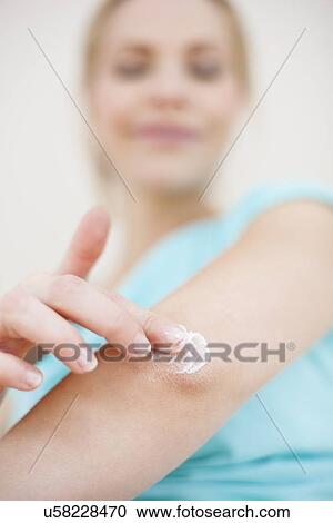 Woman applying body lotion View Large Photo Image Stock Image - Woman applying body lotion. Fotosearch