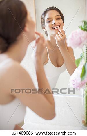 Woman applying lip balm View Large Photo Image Stock Photography - Woman applying lip balm. Fotosearch
