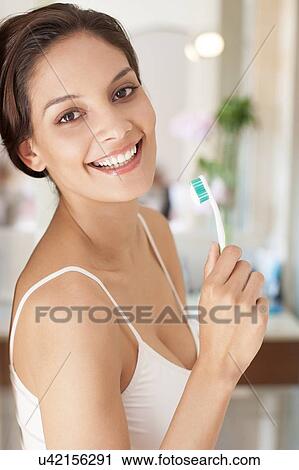 Woman brushing her teeth View Large Photo Image Stock Image - Woman brushing her teeth. Fotosearch