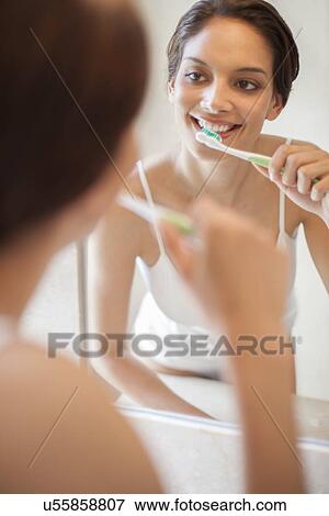 Stock Photo - Woman brushing her teeth. Fotosearch