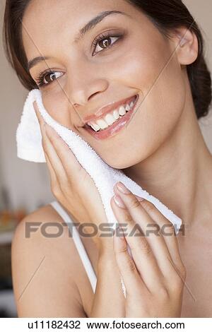 Woman cleaning her face View Large Photo Image Stock Image - Woman cleaning her face. Fotosearch