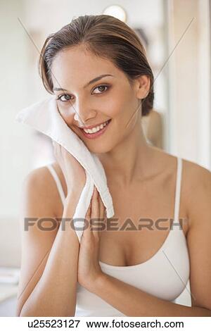 Woman cleaning her face View Large Photo Image Stock Photo - Woman cleaning her face. Fotosearch