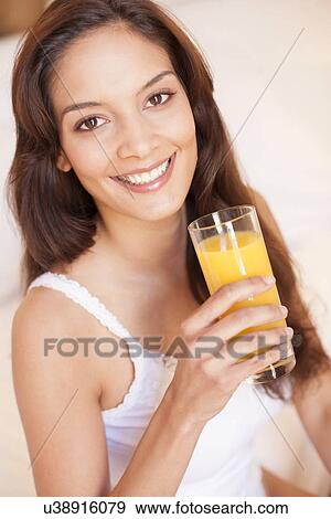 Stock Photo - Woman drinking fruit juice. Fotosearch