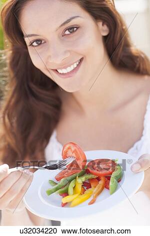 Woman eating a salad View Large Photo Image Stock Image - Woman eating a salad. Fotosearch