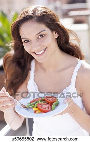 Woman eating a salad View Large Photo Image Stock Image - Woman eating a salad. Fotosearch