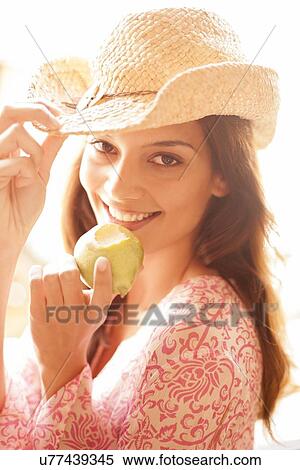 Woman eating an apple View Large Photo Image Stock Photography - Woman eating an apple. Fotosearch
