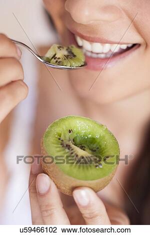 Woman eating fruit View Large Photo Image Stock Image - Woman eating fruit. Fotosearch