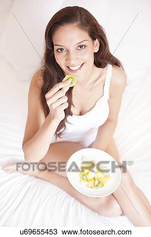Woman eating fruit View Large Photo Image Stock Image - Woman eating fruit. Fotosearch
