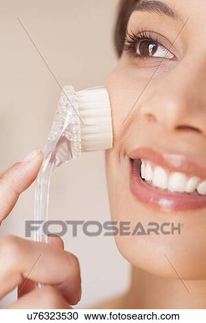 Woman exfoliating her face View Large Photo Image Stock Image - Woman exfoliating her face. Fotosearch
