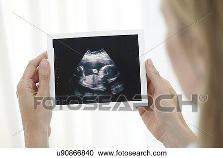 Woman looking at baby scan View Large Photo Image Stock Image - Woman looking at baby scan. Fotosearch