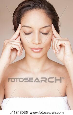 Woman massaging her face View Large Photo Image Stock Photography - Woman massaging her face. Fotosearch