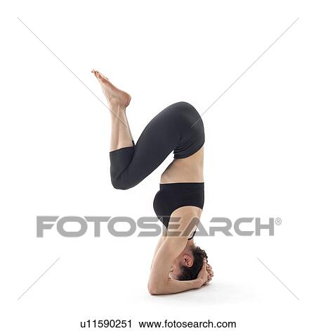 Stock Image - Woman practicing yoga. Fotosearch