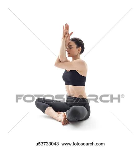 Stock Image - Woman practicing yoga. Fotosearch