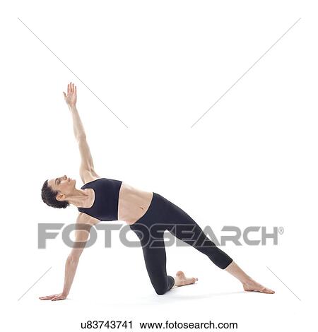 Stock Image - Woman practicing yoga. Fotosearch