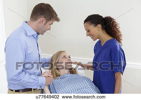 Stock Image - Woman preparing for medical procedure. Fotosearch