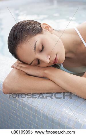 Woman relaxing in a pool View Large Photo Image Stock Photography - Woman relaxing in a pool. Fotosearch