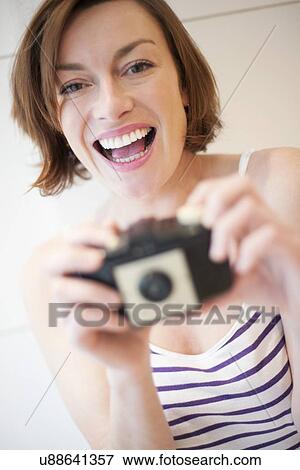Stock Photo - Woman taking photograph. Fotosearch