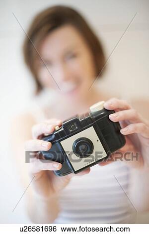 Stock Photograph - Woman taking photograph. Fotosearch