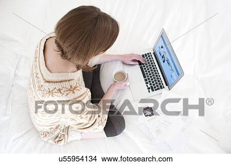 Picture - Woman using laptop computer. Fotosearch