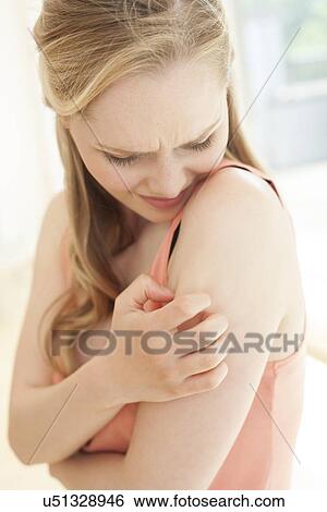 Woman with itchy arm View Large Photo Image Stock Photograph - Woman with itchy arm. Fotosearch