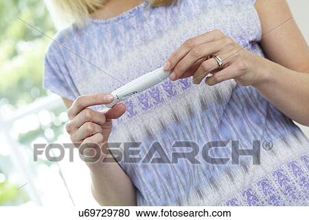 Stock Image - Woman with pregnancy test. Fotosearch