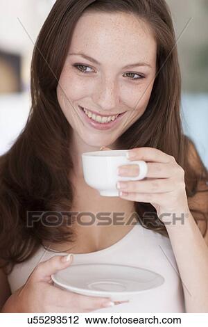 Young woman drinking coffee View Large Photo Image Stock Image - Young woman drinking coffee. Fotosearch