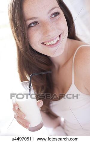 Stock Image - Young woman drinking milk. Fotosearch