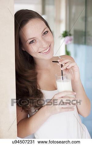 Stock Image - Young woman drinking milk. Fotosearch