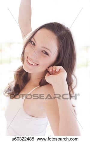 Stock Photography - Young woman stretching. Fotosearch