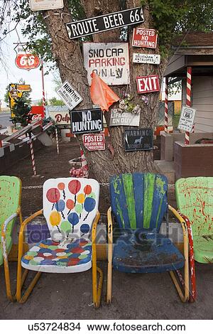 Picture - Multi-colored lawn chairs with humorous signs, Route 66, Seligman, Arizona. Fotosearch